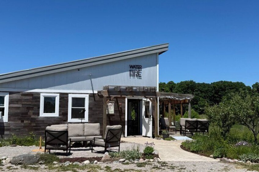 A building labeled 'WATER FIRE' with outdoor seating and a covered area. 5