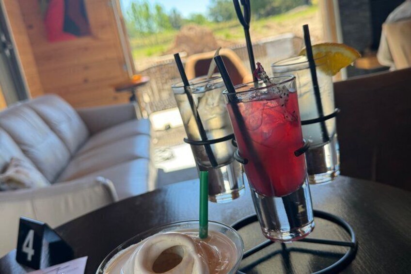 A table with drinks, a number 4 sign, and a view of the outdoors. 3