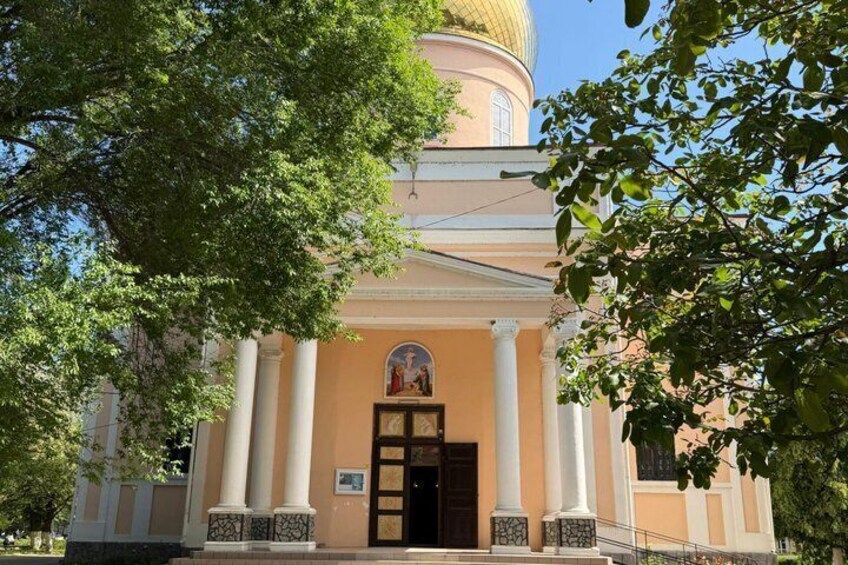 A church with a golden dome, white columns, and a central entrance. 4
