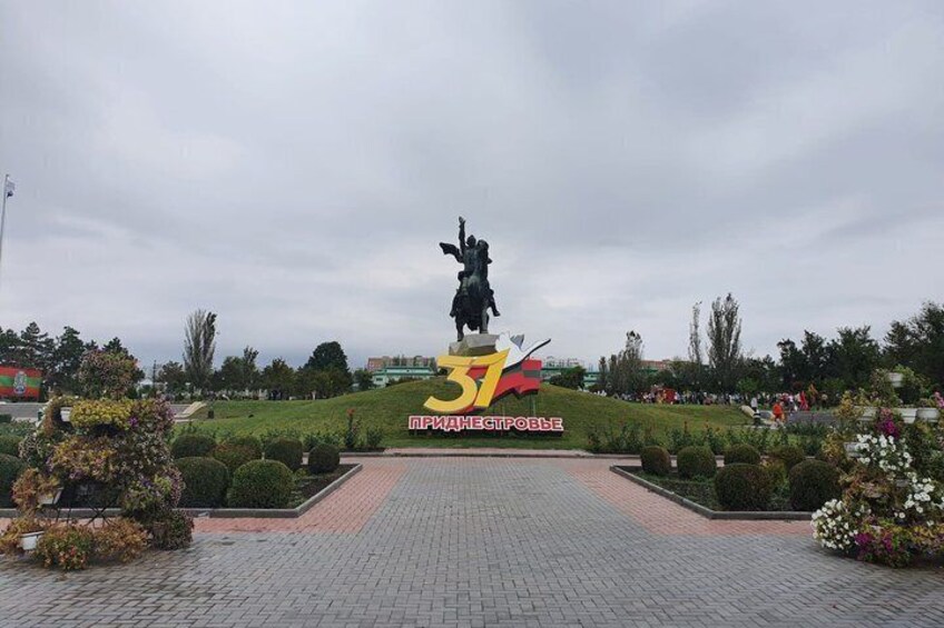 A statue on a pedestal with a '37' sign in the foreground. 1