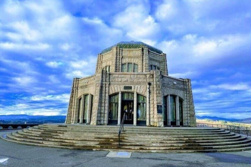 A stone building with a dome and steps leading up to it. 1