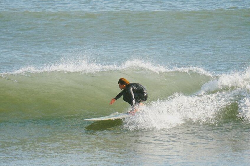 A person surfing on a wave in the ocean. 5