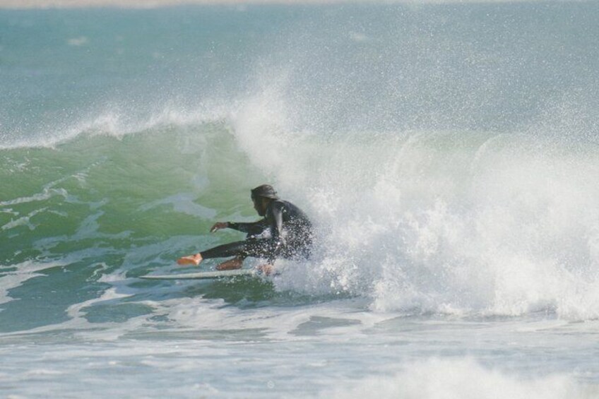 A surfer riding a wave in the ocean. 4