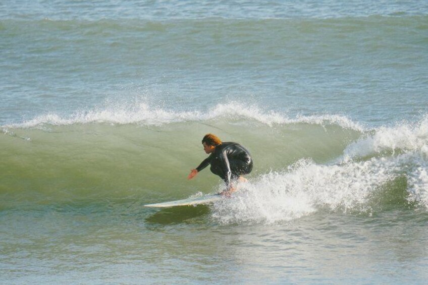 A person surfing on a wave in the ocean. 5