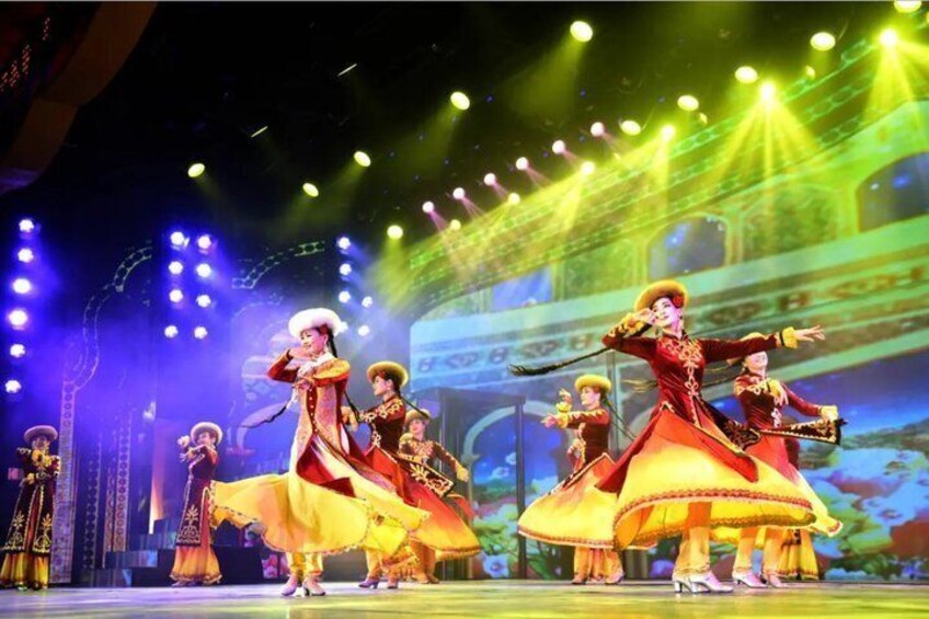 A stage performance with dancers in traditional costumes. 4