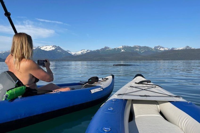 A person on a kayak with a mountain backdrop. 4