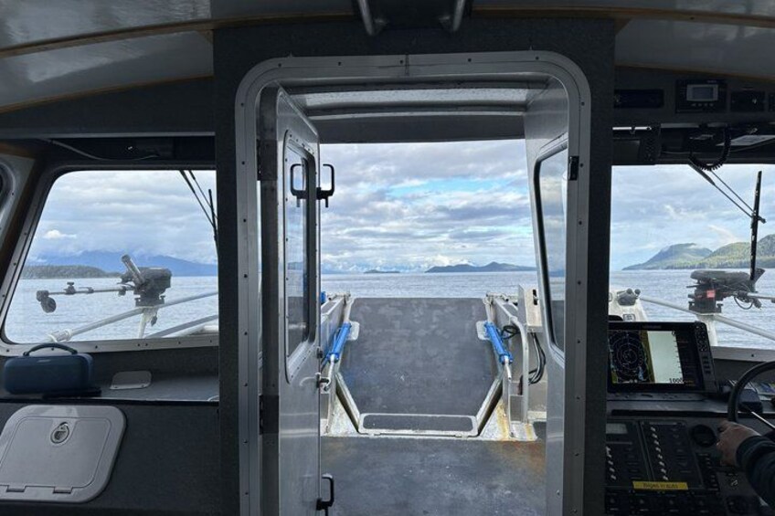 A ship's bridge with a view of the sea and distant land. 3