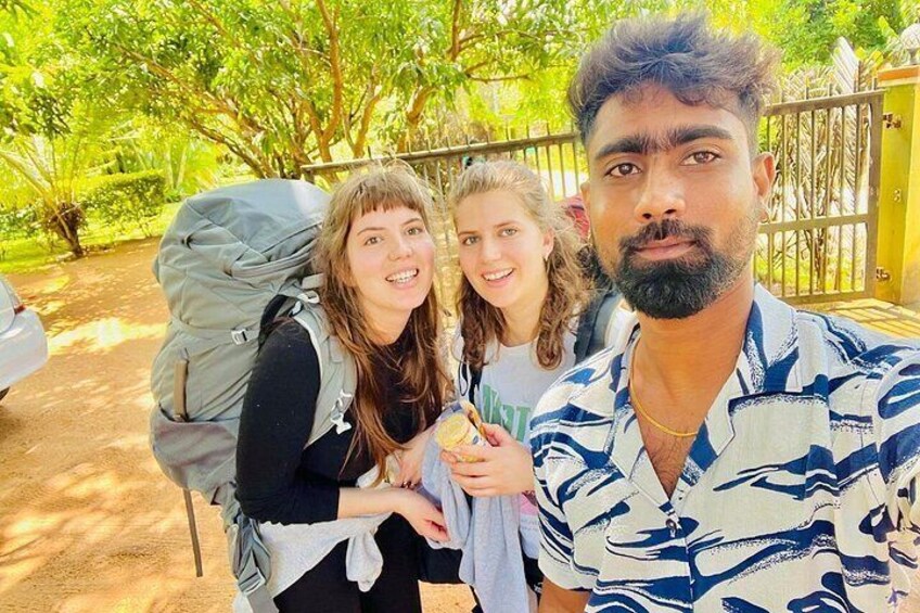 Three people outdoors with trees and a fence in the background. 3
