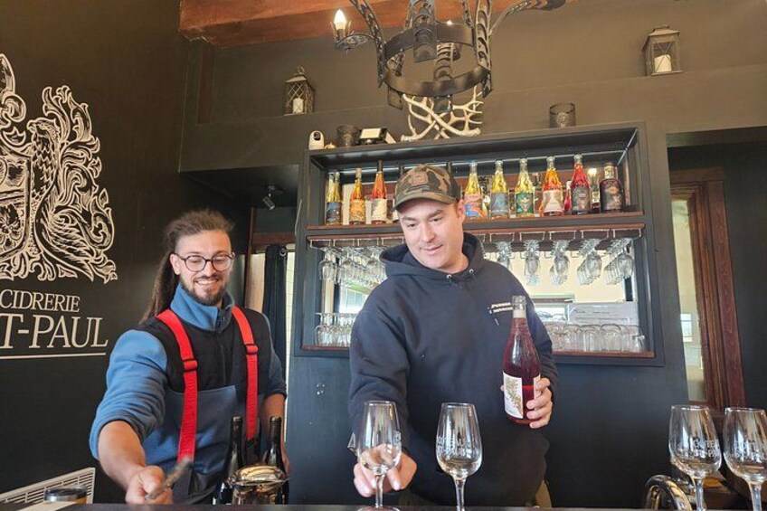 Two people at a bar, one pouring a drink into a glass. 4
