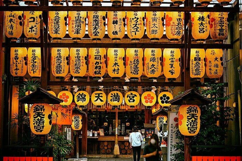 A traditional Japanese building with multiple signs and lanterns. 2