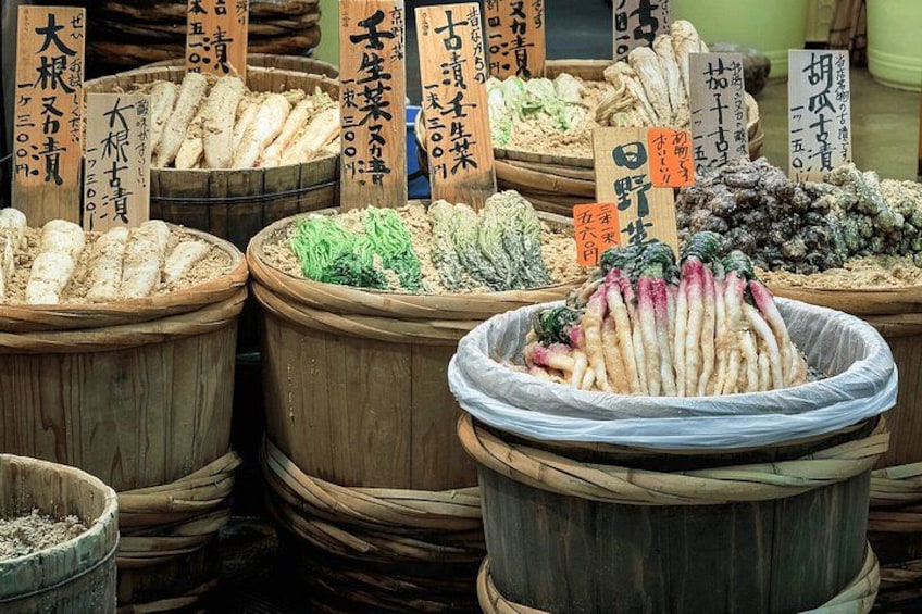 Wooden barrels filled with various types of seafood, each labeled with Japanese text. 5