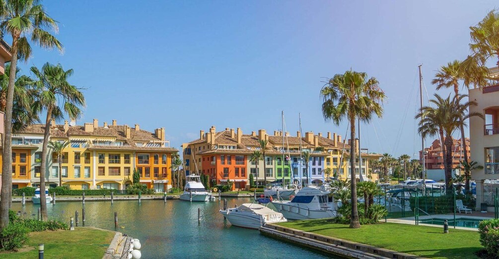 A marina with colorful buildings and boats. 1