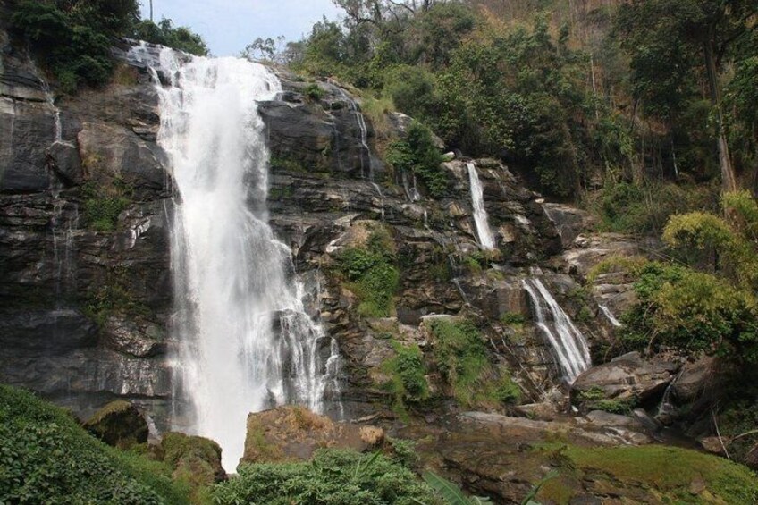 A multi-tiered waterfall surrounded by lush greenery. 2