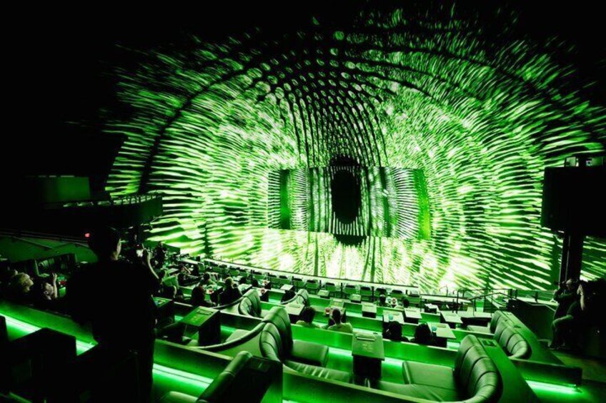 A concert with a green light show and a crowd of people. 1