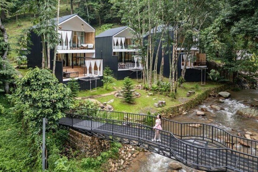 A river, wooden deck, and two modern houses with balconies. 2