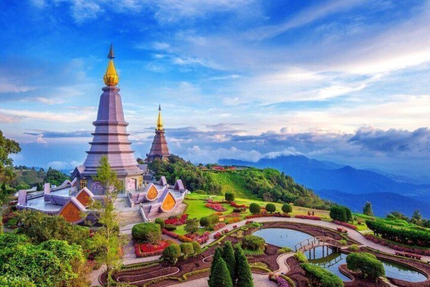 A temple complex with tiered roofs and a surrounding garden. 1