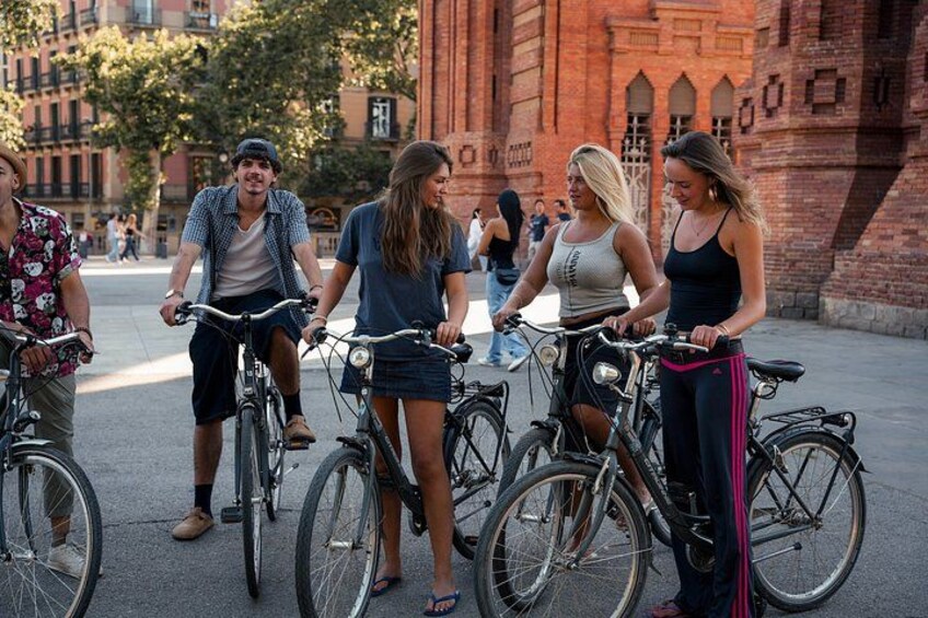 A group of people on bicycles in an urban setting with a historic building in the background. 5