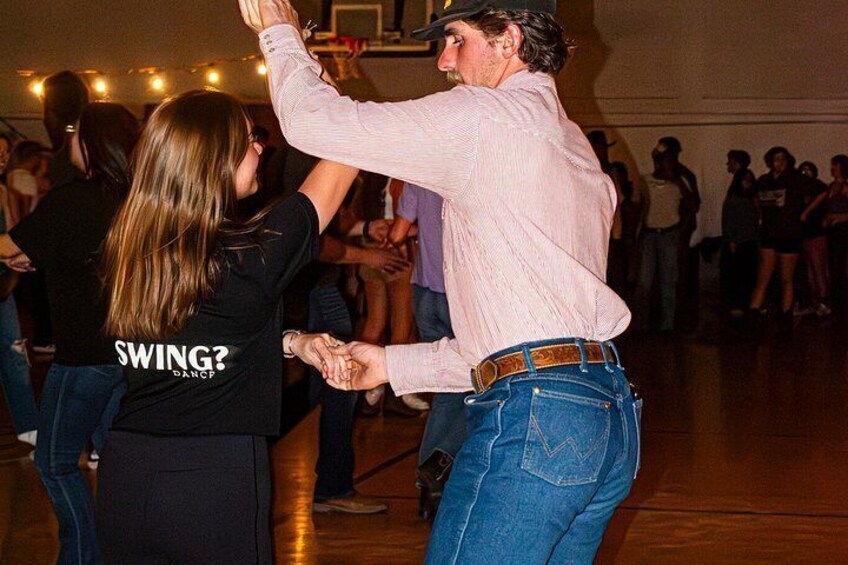 A person dancing with a partner in a social setting. 4