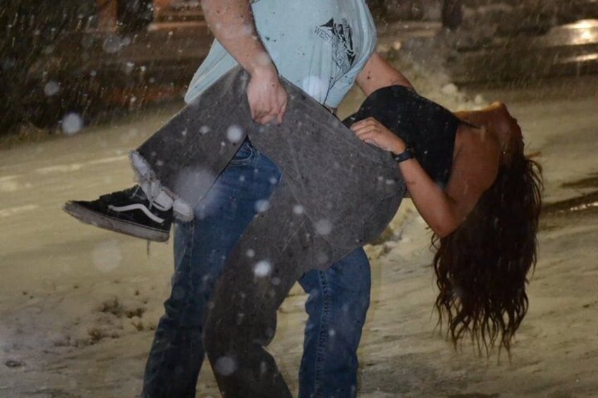 A person carrying another person in a snowy environment. 1