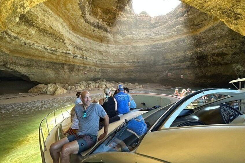 A group of people inside a cave with a boat. 4