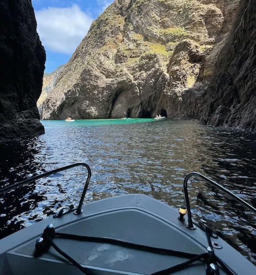 A boat in a narrow waterway between rocky cliffs. 4