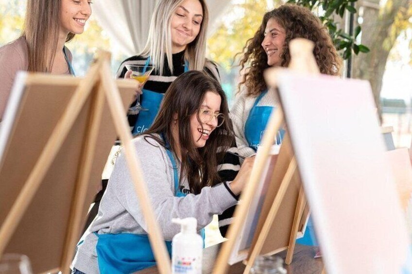 People painting on easels in an outdoor setting. 3