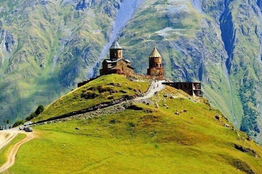A church on a hill with a road leading up to it. 1