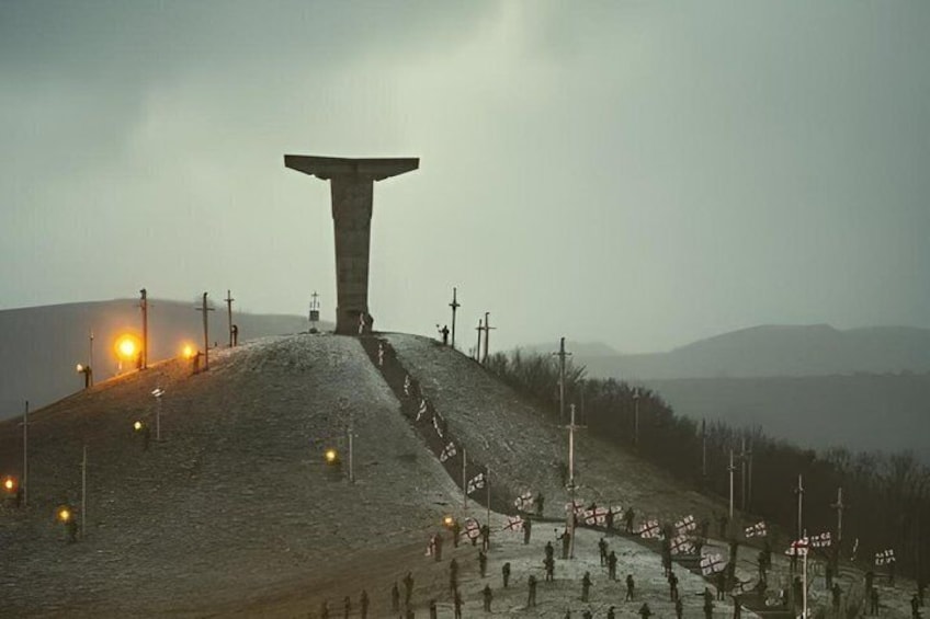A large monument on a hill with a flag-covered path leading up to it. 1