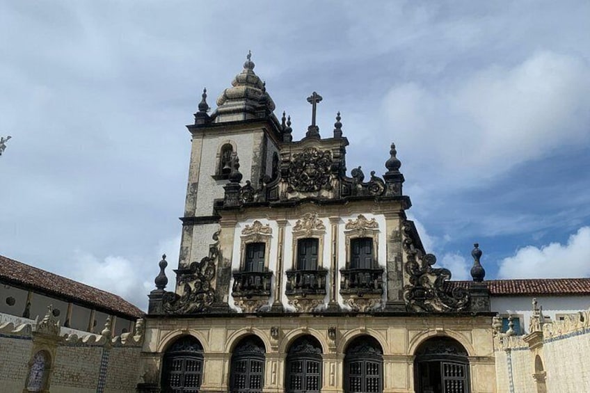 A historic building with ornate architecture, including a bell tower and detailed carvings. 5