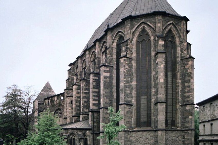 A historic church with Gothic architecture, featuring pointed arches and a large central window. 2