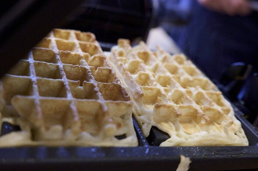 A waffle iron with waffles inside. 2