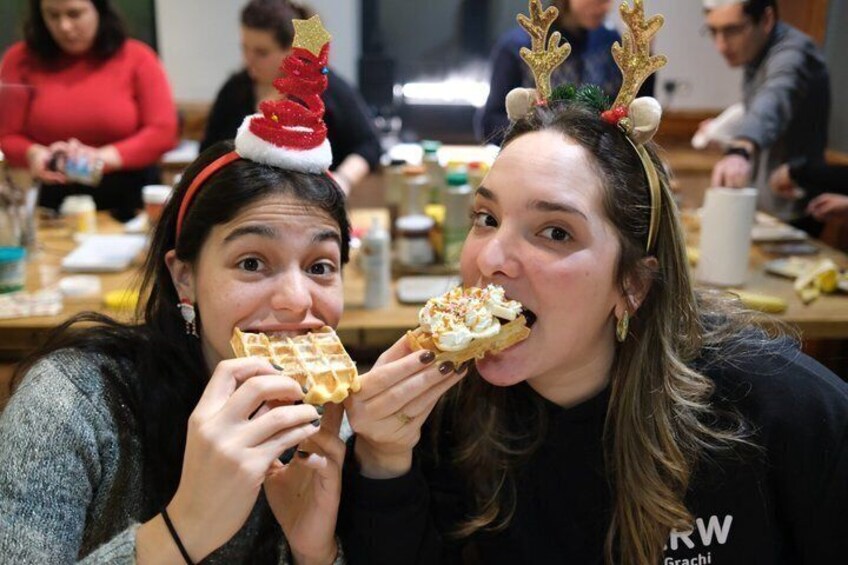 Two people wearing reindeer antlers and eating pizza. 5