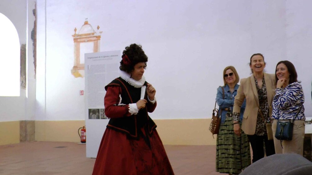 A person in historical costume, a whiteboard with text, and a building facade. 4