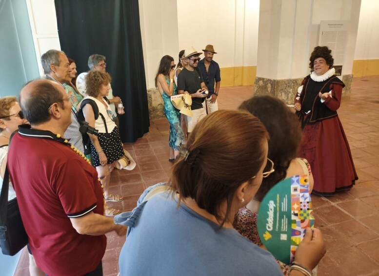 A group of people in a historical building, some wearing period costumes. 4