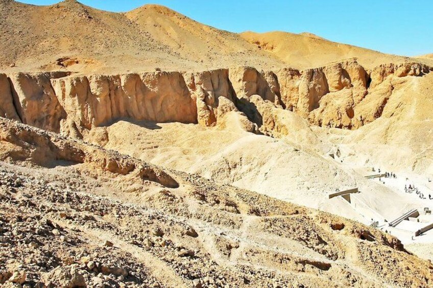 A desert landscape with rocky terrain and a clear sky. 1