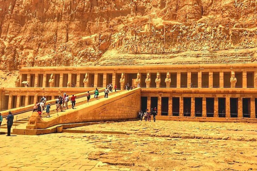A large ancient Egyptian temple with a long staircase leading to the entrance. 1