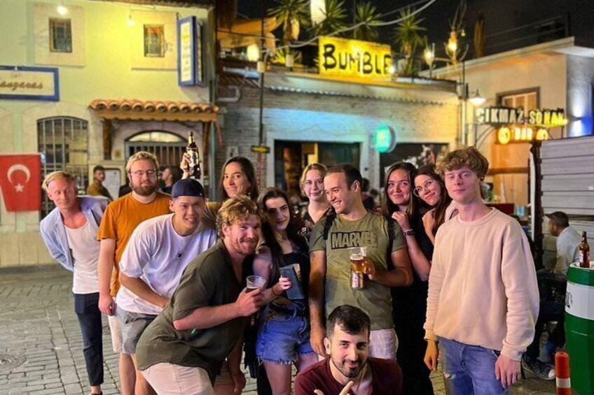 A group of people posing in front of a building with a sign that reads 'BUMBLE.' 4