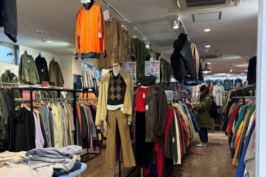 A clothing store with racks of jackets and coats. 5
