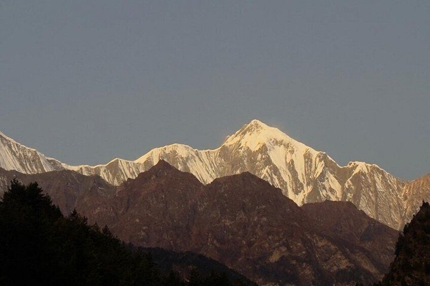 A mountain range with snow-capped peaks and forested valleys. 2
