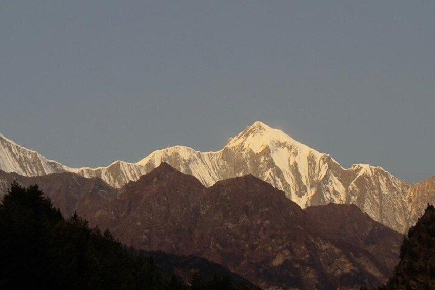 A mountain range with snow-capped peaks and forested valleys. 2