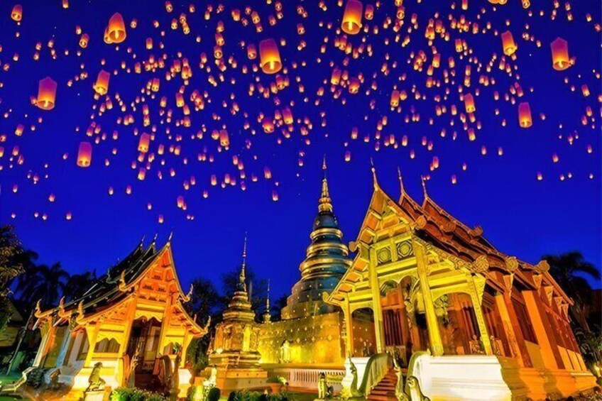A temple complex with traditional architecture and numerous sky lanterns. 1