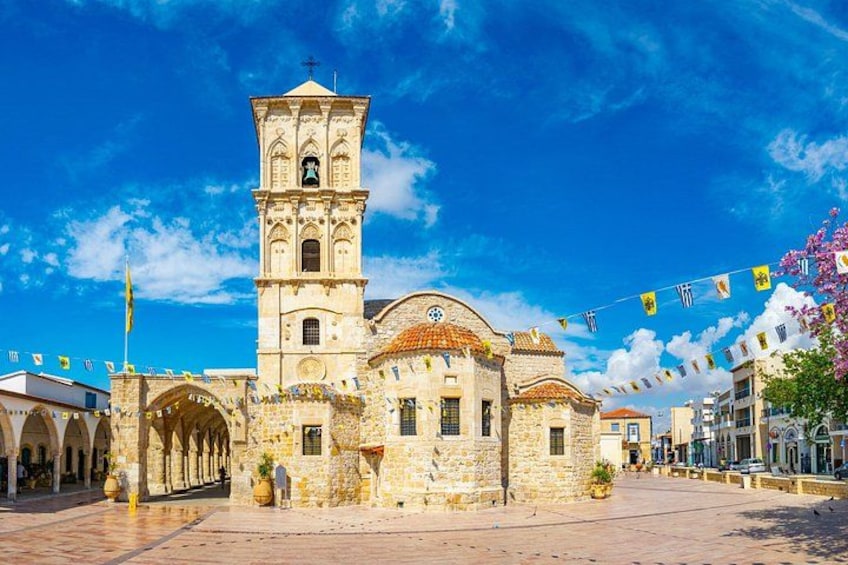 A historic church with a bell tower, arches, and a tiled roof. 1