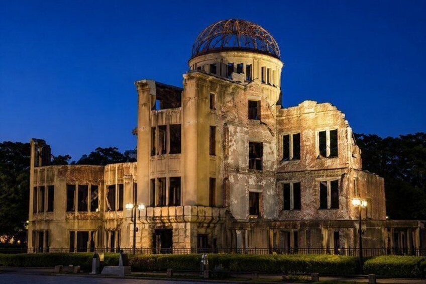 A large, historic building with a dome and columns, partially in ruins. 3