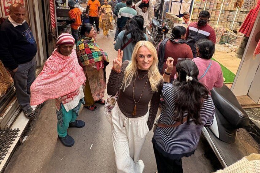 A crowded outdoor market with people shopping and interacting. 3
