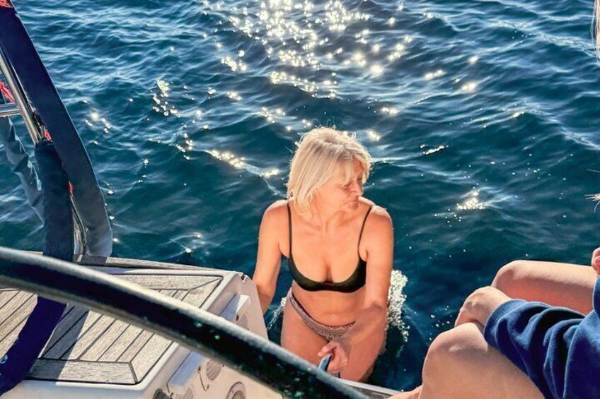 A person in a bikini on a boat, water splashing around. 1