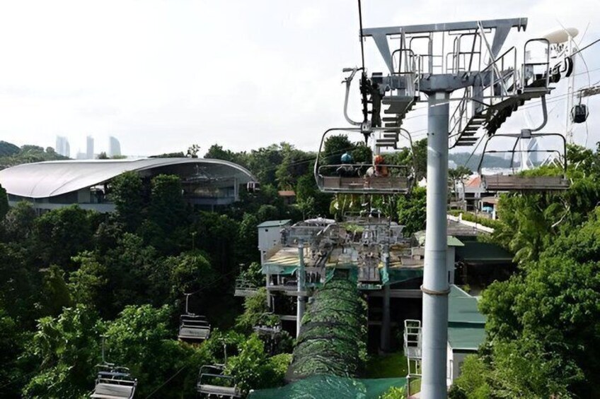 A cable car system, a modern building with a curved roof, and a dense green forest. 4