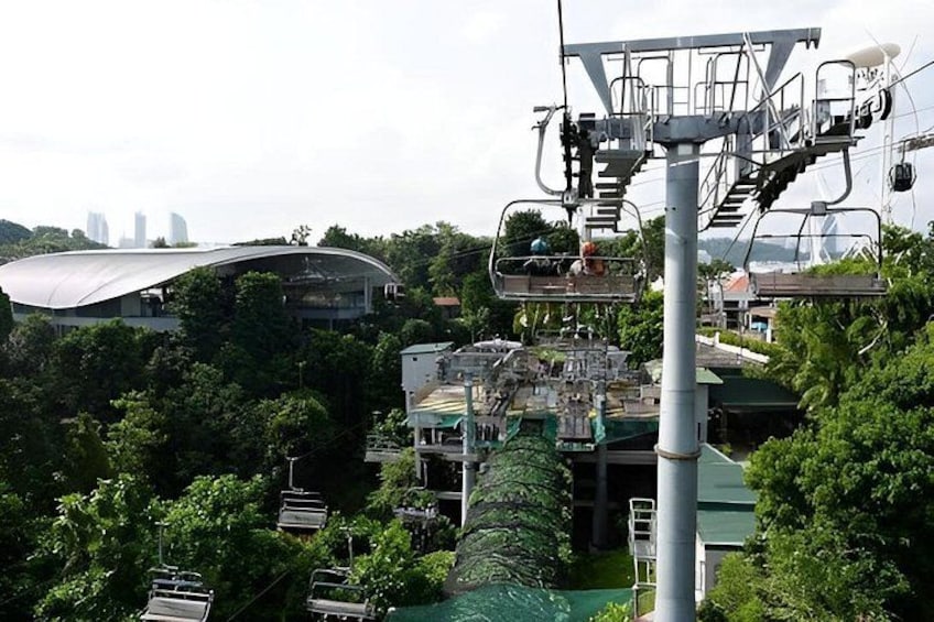 A cable car system, a modern building with a curved roof, and a city skyline in the background. 4