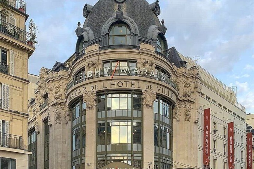A historic building with ornate architecture, including a dome and columns, and the name 'Bazar de l'Hôtel de Ville' prominently displayed. 4