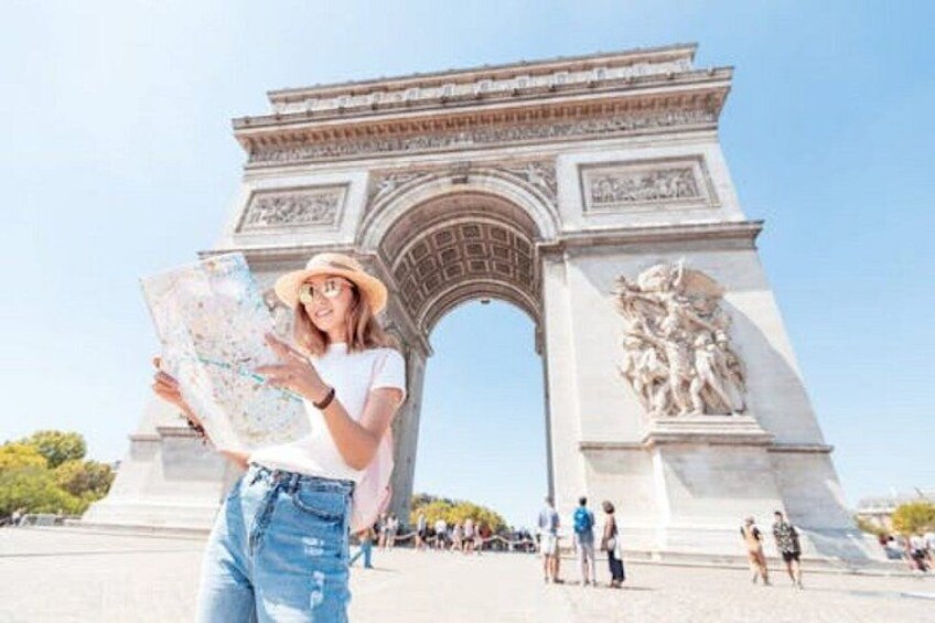 A person holding a map in front of the Arc de Triomphe in Paris. 1
