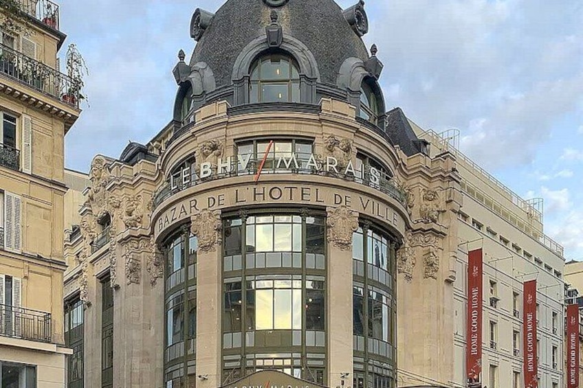 A historic building with ornate architecture, including a dome and columns, and the name 'Bazar de l'Hôtel de Ville' prominently displayed. 4